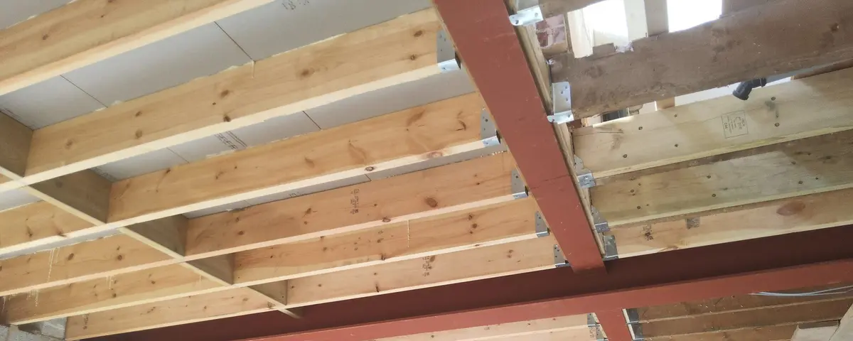 RSJ steel beam being installed during load-bearing wall removal by Simplify Structures