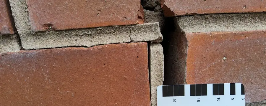 Chartered structural engineer measuring wall crack during Specific Structural Inspection in Midlands